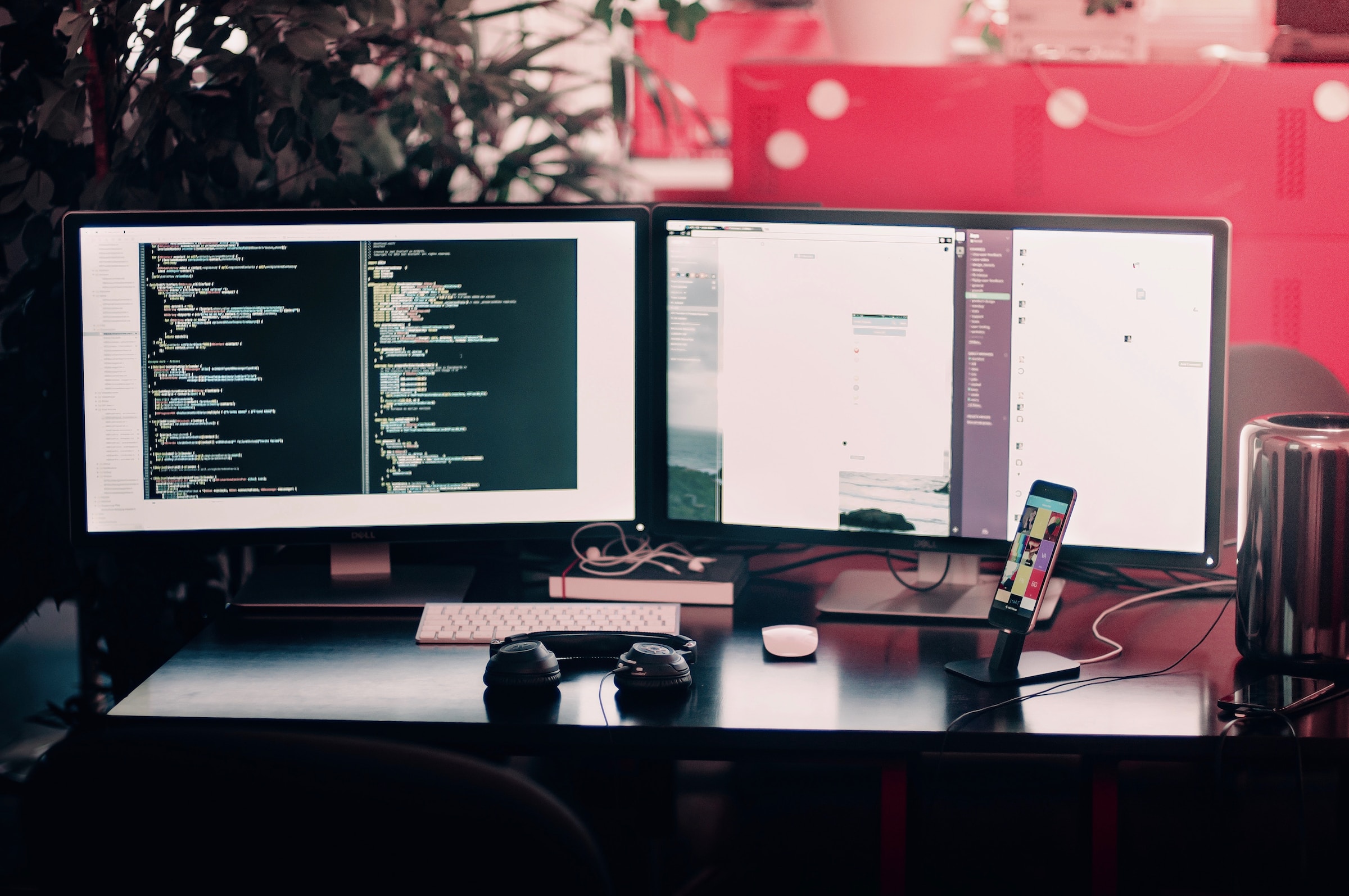 Two monitors showcasing code for a website.